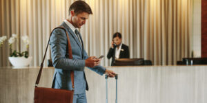Business person in a hotel using a smartphone