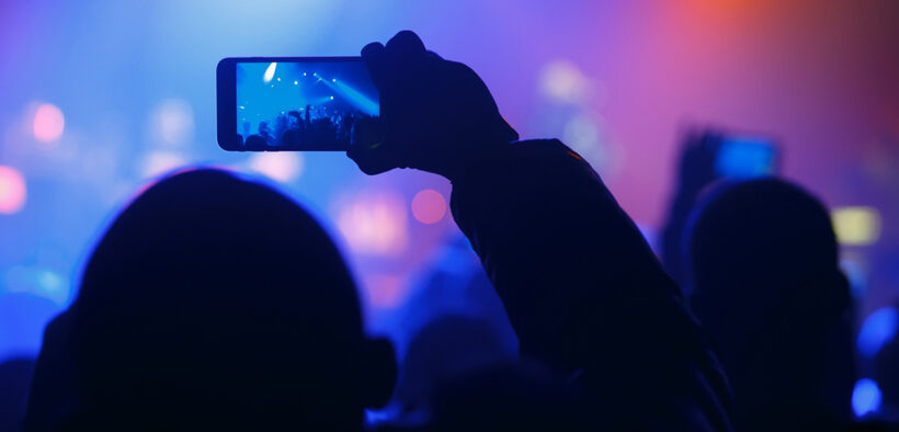 Person holding smartphone at an event